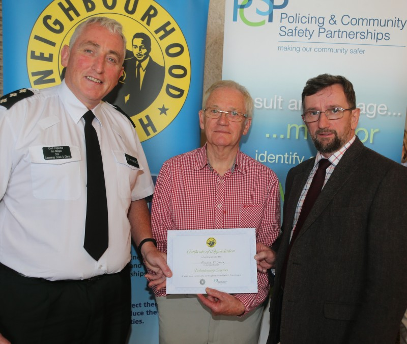 Maurice McCurdy pictured receiving his award for over ten years’ service as a Neighbourhood Watch co-ordinator with Chief Inspector Ian Magee and PCSP Chairperson Alderman George Duddy.