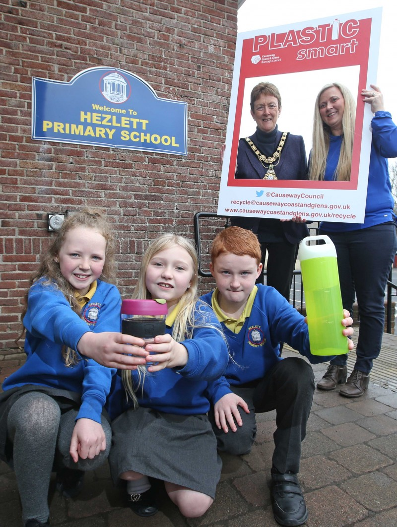 Luka, Brooke and Ross, pupils from Hezlett Primary School, celebrate their 'Plastic Smart' award with the Mayor of Causeway Coast and Glens Borough Council Councillor Joan Baird OBE and class teacher Mrs Williams.
