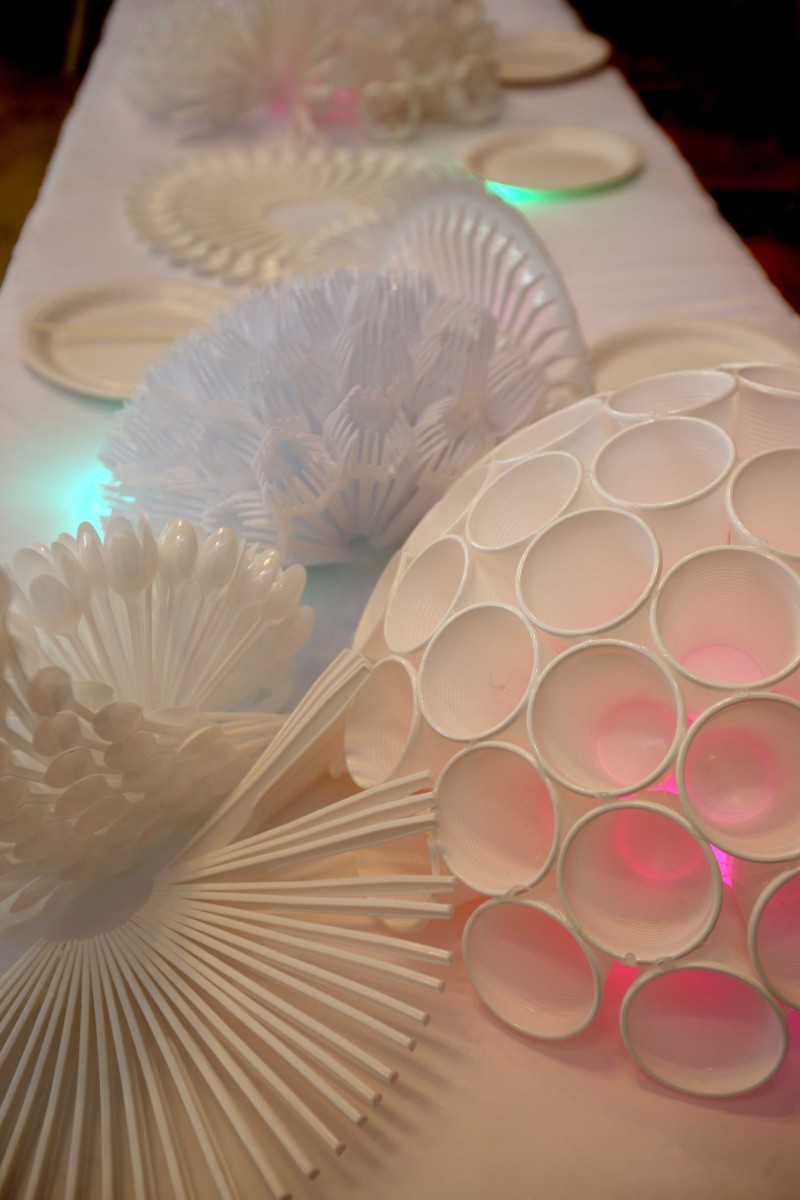 The 'Uniform of Debris' art installation takes the form of a table set up for a dinner party, with plastic cutlery and plates constructed to resemble a coral reef.
