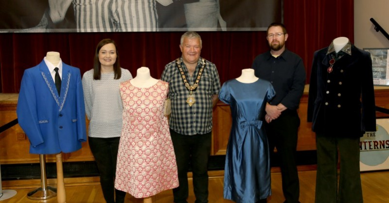 The Mayor of Causeway Coast and Glens Borough Council Councillor Ivor Wallace pictured with Museums Officers Rachel Archibald (left) and Nic Wright (right), with some of the fashion from the dance hall era which is on display in the new exhibition in Coleraine Town Hall.