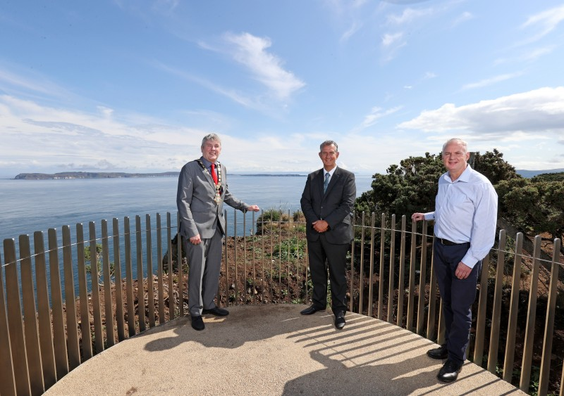Minister for Agriculture, Environment and Rural Affairs Edwin Poots experiences the new viewing platform at Portaneevy outside Ballintoy with the Mayor of Causeway Coast and Glens Borough Council Councillor Richard Holmes and Councillor Dermott Nicholl, Chair of the LAG Board.
