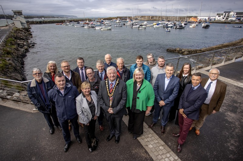 The Mayor of Causeway Coast and Glens, Councillor Steven Callaghan joins David Jackson Chief Executive, elected members from the Borough and representatives from Dept for Communities, GM Design Associates, Northstone (contractors) Portrush Town Forum and Portrush Heritage Group for the official completion of the Portrush Kerr Street Harbour Public Realm scheme.