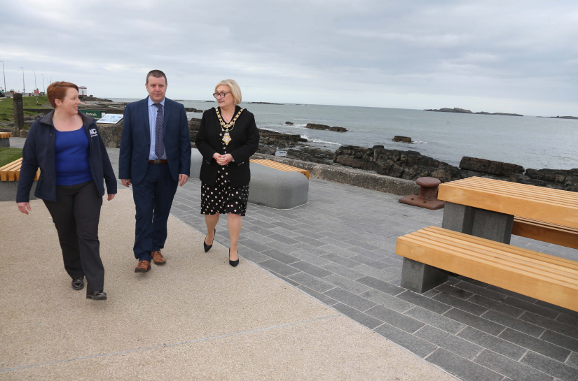 Ian McQuitty from Department for Communities pictured with the Mayor of Causeway Coast and Glens Borough Council Councillor Brenda Chivers and Rebecca Henderson from contractor FP McCann in Portrush where a major public realm scheme to transform the town is nearing completion. The significant programme includes new granite paving, lighting columns and embellished railings along with contemporary benches and picnic tables.