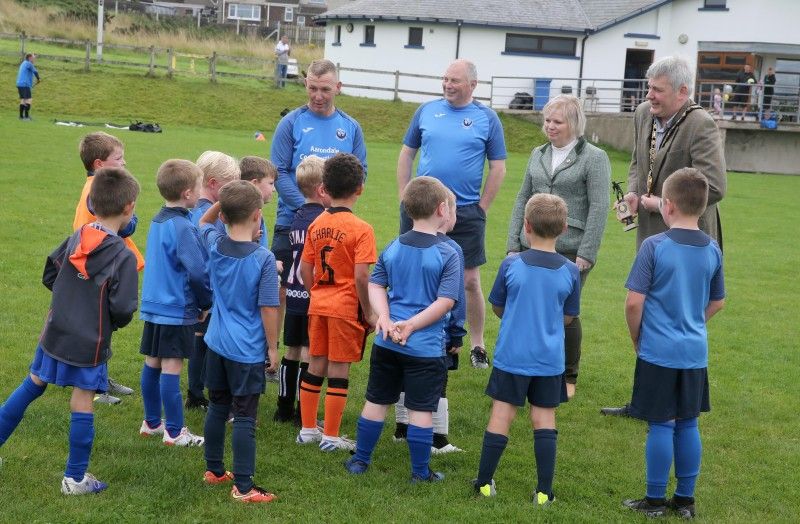 The Mayor of Causeway Coast and Glens Borough Council, Councillor Richard Holmes and Chairperson of Council’s NI 100 Working Group, Councillor Michelle Knight-McQuillan join a team talk at the Football Summer Camp in Portstewart.