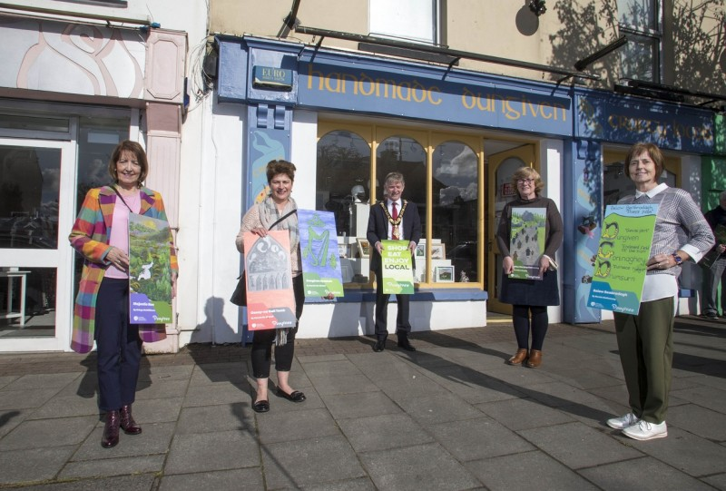 Winners of the public art competition with their banner designs that are welcoming residents, shoppers and visitors to Dungiven, while promoting the importance of ‘Shop Eat Enjoy Local’.​