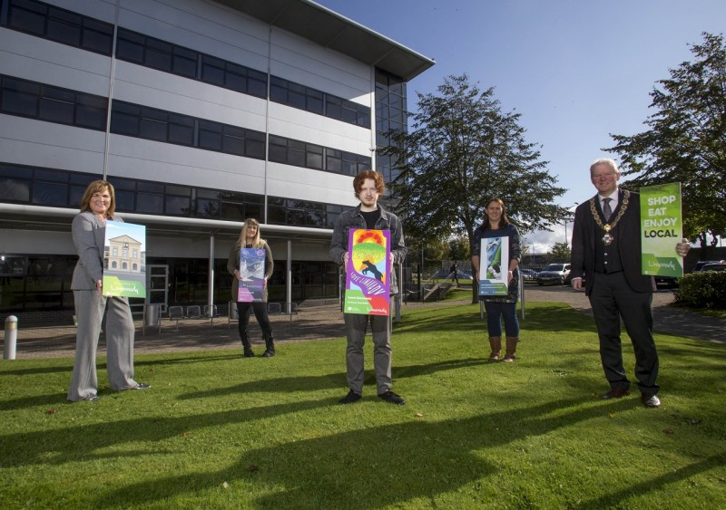 Artists and art department staff with the artwork created by North West Regional College students that has been selected for the new town centre banners.