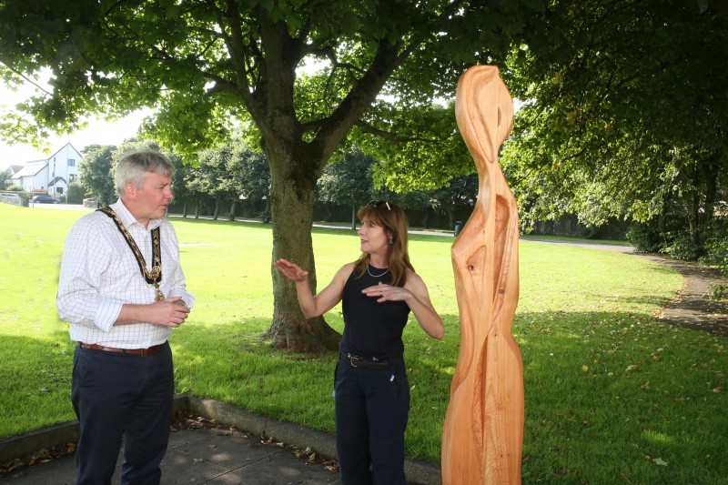 The Mayor of Causeway Coast and Glens Borough Council Councillor Richard Holmes learns more about the ‘More is Different’ series of sculptures from artist Sara Cunningham Bell at Flowerfield Park in Portstewart.