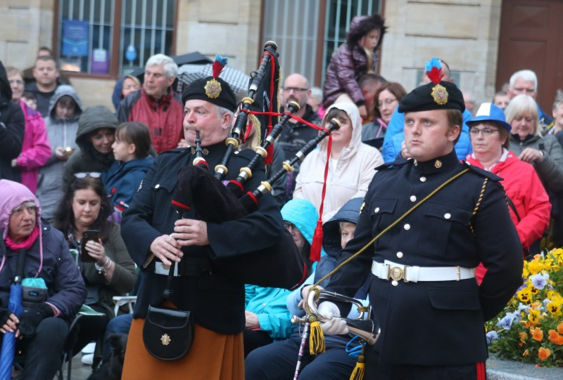 Crowds gather behind piper Robert Bratty and bugler David Granleese at the Platinum Jubilee beacon lighting event in Coleraine.