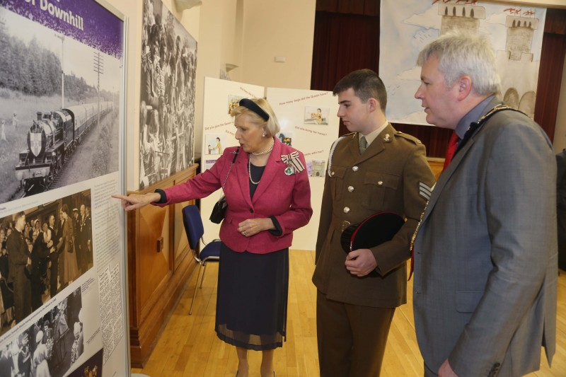 Lord Lieutenant for County Londonderry Mrs Alison Millar, Cadet Bombardier Christopher Johnston of the Royal Artillery in Coleraine and the Mayor of Causeway Coast and Glens Borough Council Councillor Richard Holmes look at one of the information panels on display as part of the new Platinum Jubilee exhibition in Coleraine Town Hall.