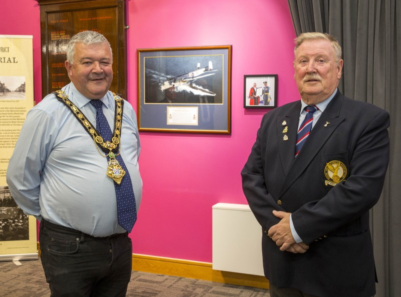 The Mayor of Causeway Coast and Glens Borough Council, Councillor Ivor Wallace, pictured with William Mulligan, Chairman of the Roe Valley branch of the Royal Air Force Association with the new framed items on display in the background.