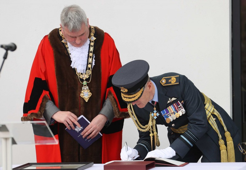 Mayor of Causeway Coast and Glens Borough Council Richard Holmes and Air Marshal Sir Gerry Mayhew sign the Freedom Register during the Freedom of the Borough ceremony held in Limavady on Friday.
