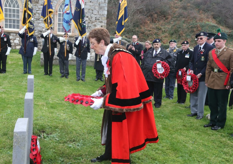 The Mayor of Causeway Coast and Glens Borough Council, Councillor Joan Baird OBE, lays a wreath in St Thomas’ Church graveyard to remember the lives lost on HMS Racoon and HMS Viknor.