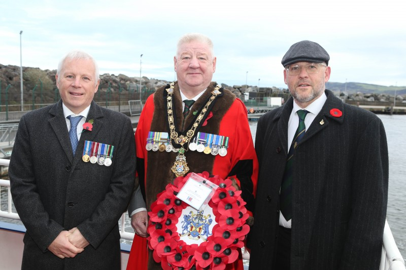 The Mayor of Causeway Coast and Glens, Councillor Steven Callaghan alongside the bugler Adrian Millar and Mark Heaney from Bushmills Royal British Legion.