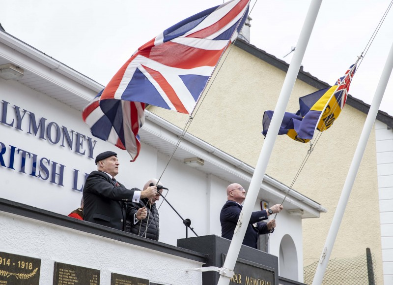 Flags are lowered at Ballymoney War Memorial during the Armistice Day service.