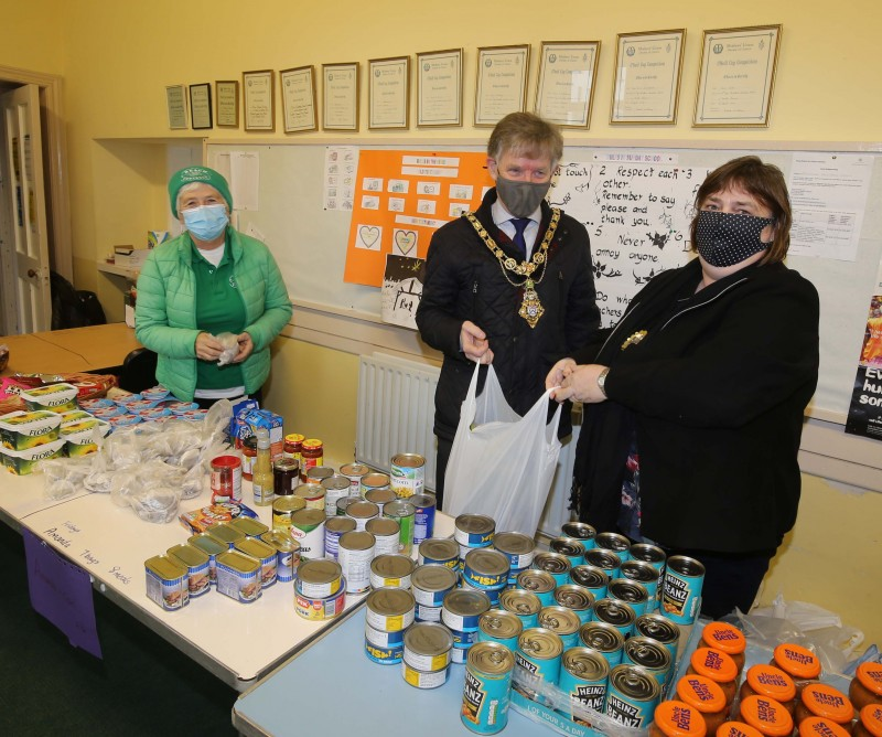 : Mayor of Causeway Coast and Glens Borough Council, Alderman Mark Fielding and his wife Phyllis help pack donations at the Portrush Reach community foodbank facility  with Reach volunteer Val McDonald