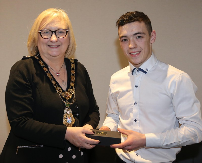 The Mayor of Causeway Coast and Glens Borough Council Councillor Brenda Chivers presents rising motorcycle star Eunan McGlinchey with a token to mark his recent success as Junior Supersport Champion