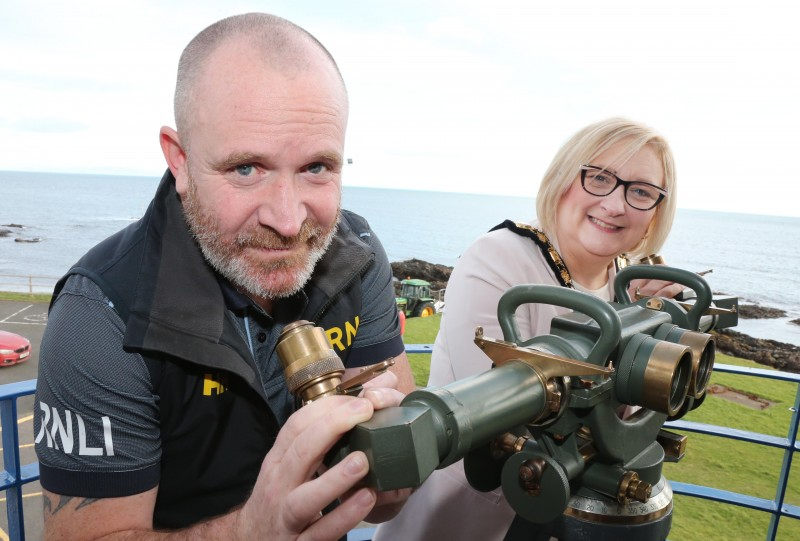 Crew member Paul Fullalove shows the Mayor of Causeway Coast and Glens Borough Council Councillor Brenda Chivers an old anti-aircraft sighting device donated by Joe Mitchell in 1972.