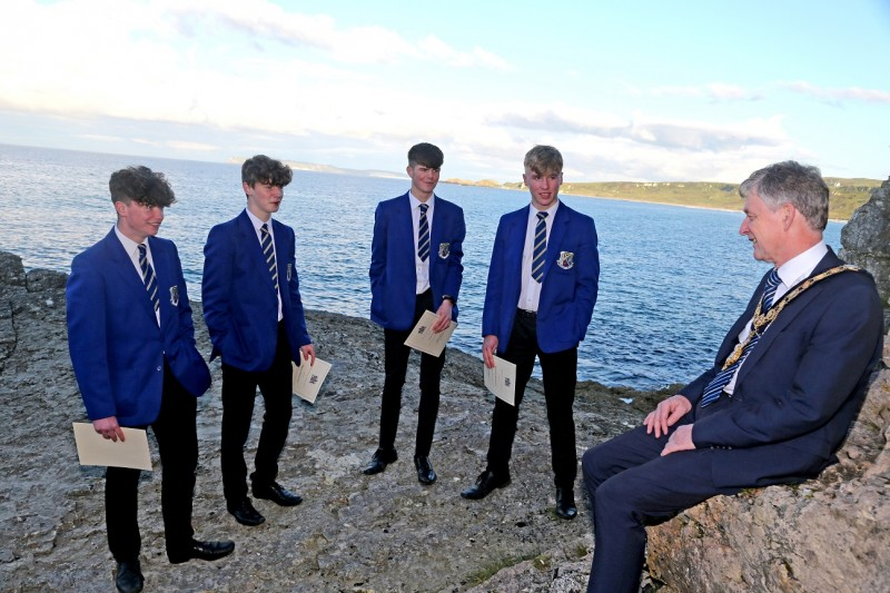The Mayor of Causeway Coast and Glens Borough Council Alderman Mark Fielding pictured with the four teenagers involved in the rescue at Whitepark Bay earlier this year Josh Schnell, Shane McKenna Niall Óg McGuigan and Michael Quinn.