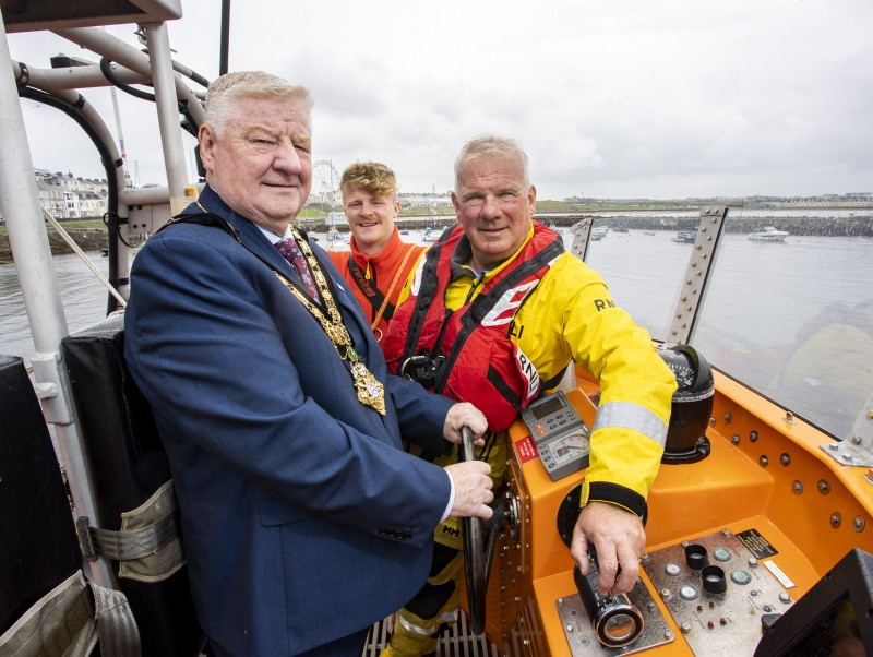 Mayor of Causeway Coast and Glens, Councillor Steven Callaghan with Portrush RNLI Coxswain Des Austin and RNLI Lifeguard James Wright