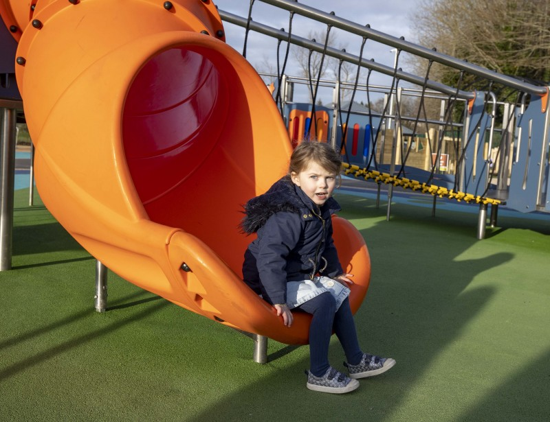 Three-year-old Lara enjoys some play time at Limavady Accessible Play Park.