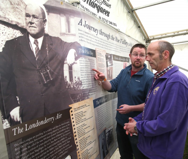 Nic Wright from Causeway Coast and Glens Borough Council's Museums Service looks at the Sam Henry exhibition with Andy from Roe Valley Ancestral Researchers group.
