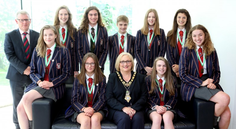 The Mayor of Causeway Coast and Glens Borough Council Councillor Brenda Chivers pictured with the woman’s under 16 eight winning rowing team and Dr David Carruthers, Coleraine Grammar School Principal.