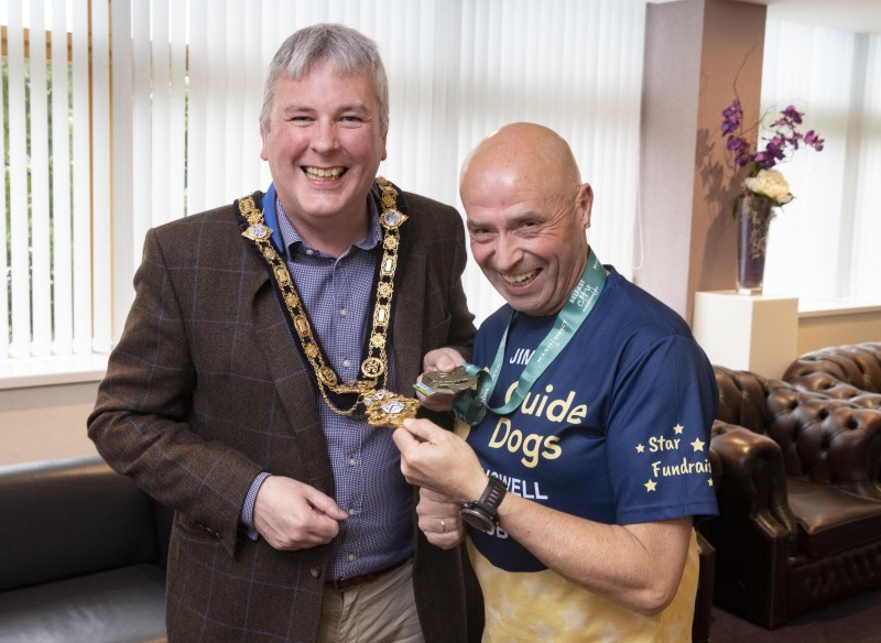 Jim Bradley and the Mayor of Causeway Coast and Glens Borough Council, Councillor Richard Holmes share a laugh as they compare chains and medals during the reception at Cloonavin.