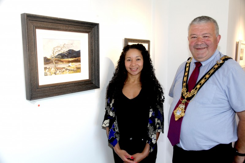 The Mayor of Causeway Coast and Glens Borough Council Councillor Ivor Wallace pictured with Arts and Cultural Facilities Officer Esther Alleyne during his recent visit to Roe Valley Arts and Cultural Centre where Jim Holmes’ new exhibition is on display.