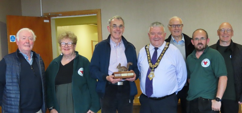 Pictured with the Mayor of Causeway Coast and Glens Borough Council, Councillor Ivor Wallace, are Glens Red Squirrel Group members Tom Mc Naughton, Liz Weir, Gerard McCaughan, Joe McKavanagh, Daniel McAfee (Group Chair) and Gabriel McCauley.