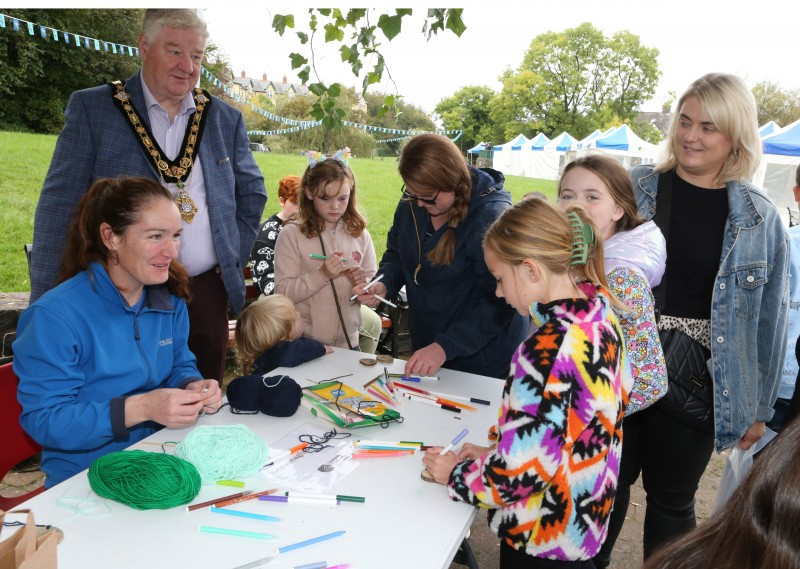 Some young visitors show the Mayor of Causeway Coast and Glens, Councillor Steven Callaghan their crafting skills at this year’s Salmon and Whiskey Festival.