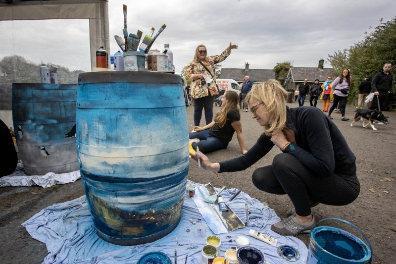 Local artists Sarah Carrington, Michelle McGarvey and Linda Mullholland were set up in Millenium Park over the weekend, for Enterprise Causeway’s community barrel decorating project.