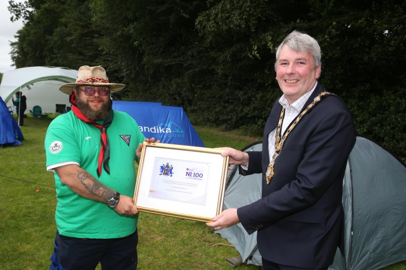 The Mayor of Causeway Coast and Glens Borough Council Councillor Richard Holmes makes a special presentation to Jonny Hoy, Group Scout Leader of Ballymoney Scout Group to mark 100 years of scouting in Ballymoney.