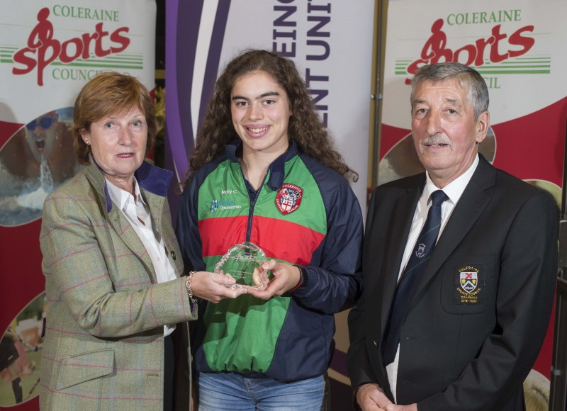 Molly Curry, winner of the Junior Sports Woman title at Coleraine Sports Awards receives her award from special guest Wilma Erskine and John Church, Chair of Coleraine Sports Council.