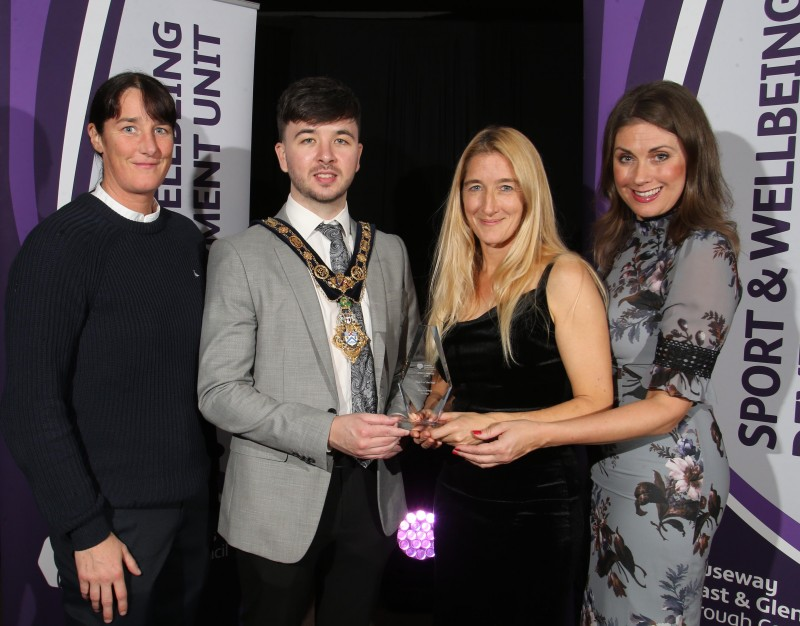 Annette Wilson (Hockey), winner of the Coach of the Year award, pictured with the Mayor of Causeway Coast and Glens Borough Council Councillor Sean Bateson, Master of Ceremonies Sarah Travers and Gill Small representing award sponsor Smallcost Carpets.