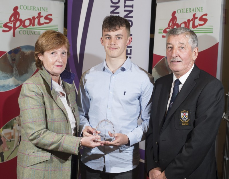 Oliver Swinney, Junior Sportsman of the Year at Coleraine Sports Awards receives his award from special guest Wilma Erskine and John Church, Chair of Coleraine Sports Council.