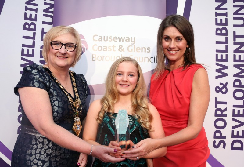 The Junior Sportswoman of the Year award, sponsored by Grafton Recruitment, was won by Caitlin Henry pictured with the Mayor of Causeway Coast and Glens Borough Council Councillor Brenda Chivers and awards host Sarah Travers.