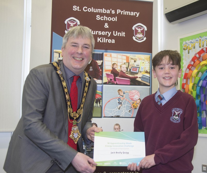 The Mayor of Causeway Coast and Glens Borough Council Councillor Richard Holmes presents a certificate to Jack Brolly Quigg who took part in the Energy Innovation Challenge.
