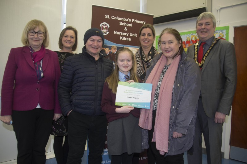The Mayor of Causeway Coast and Glens Borough Council Councillor Richard Holmes pictured with Energy Innovation Challenge winner Sophia Maguire, her parents Caroline & Kevin and members of staff from St Columba’s Primary School in Kilrea L-R Principal Mrs Celine Kielt, and teachers Mrs Geraldine Martin & Miss Sue-Anne McKiernan.