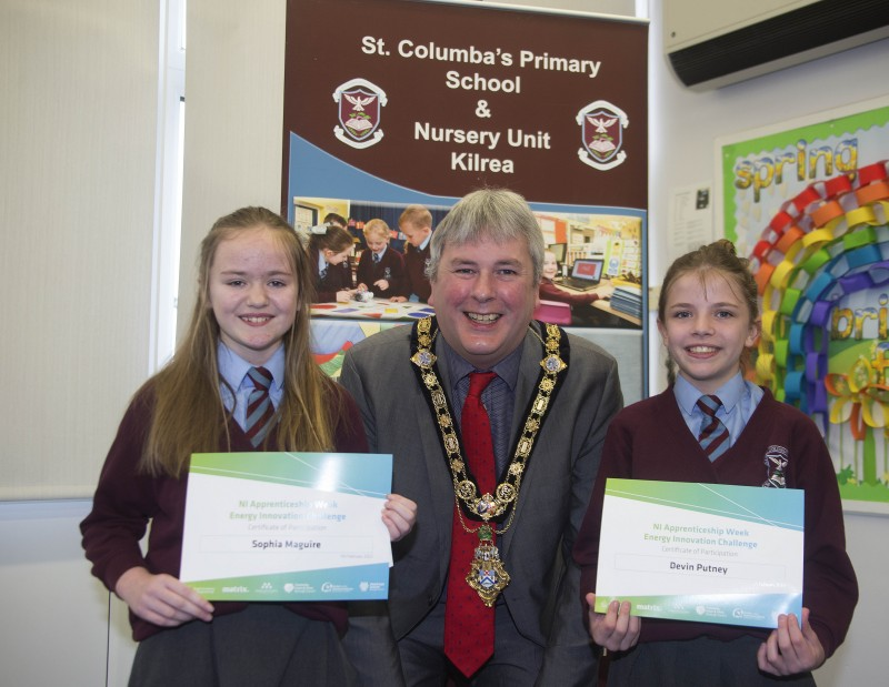 The Mayor of Causeway Coast and Glens Borough Council Councillor Richard Holmes presents a certificate to Sophia Maguire and Devin Putney.