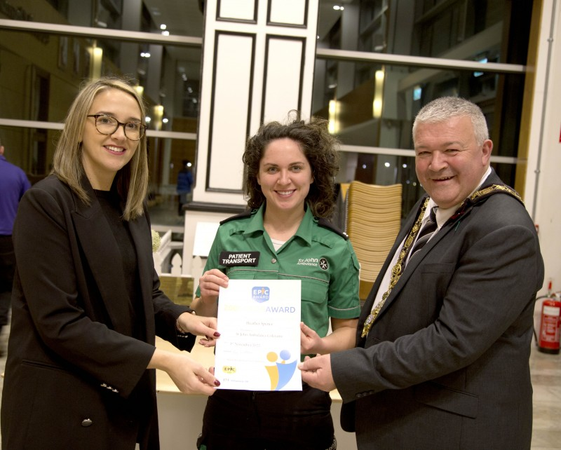 Ciara Mc Nickle from Causeway Volunteer Centre and the Mayor of Causeway Coast and Glens Borough Council, Councillor Ivor Wallace presenting an EPIC Award Certificate to St John Ambulance volunteer Heather Spence.