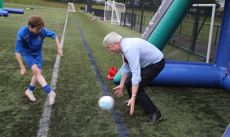 Mayor of Causeway Coast and Glens Borough Council, Councillor Richard Holmes shows off his skills with young players at the football camp at Scroggy Road.
