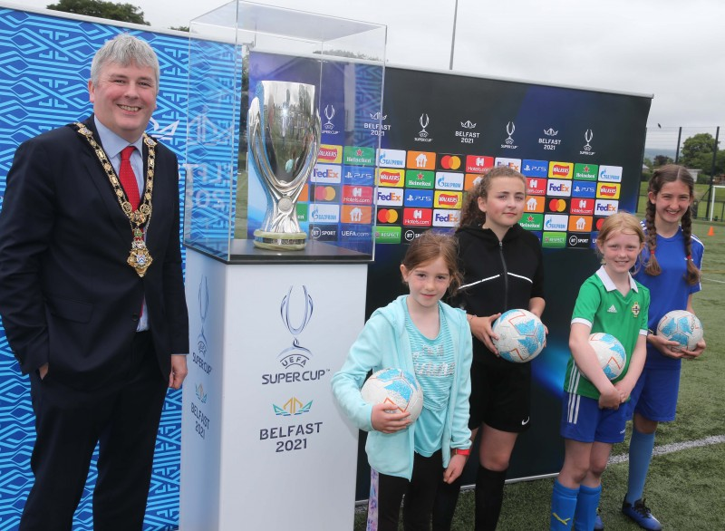Mayor of Causeway Coast and Glens Borough Council, Councillor Richard Holmes and young female players with the UEFA Super Cup at the football camp hosted in partnership by Causeway Coast and Glens Borough Council and the Irish Football Association.