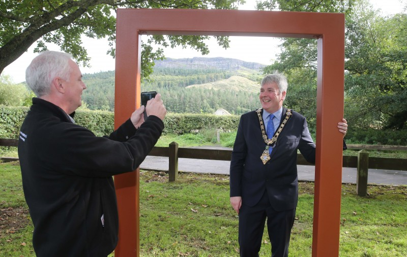 The Mayor of Causeway Coast and Glens Borough Council Councillor Richard Holmes tries out the Picture This frame at Swann’s Bridge with Councillor Dermot Nicholl, Chair of the Causeway Coast and Glens Local Action Group.