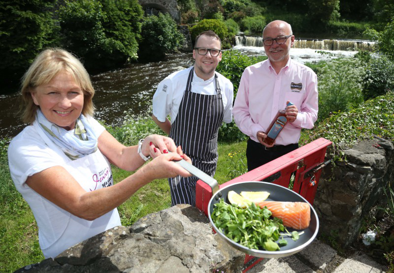 The River Bush provides the stunning backdrop as Jenny Bristow and Nial Mehaffey and Chris Gibson from Bushmills Distillery look ahead to the Bushmills Salmon and Whiskey Festival which takes place on June 17th and 18th.
