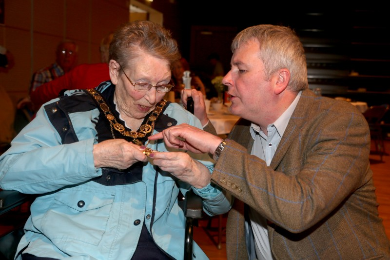 The Mayor of Causeway Coast and Glens Borough Council, Councillor Richard Holmes, shows his chain of office to one of the guests at the Vintage Tea Dance.