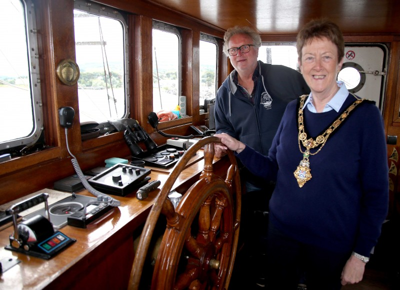 The Mayor of Causeway Coast and Glens Borough Council, Councillor Joan Baird OBE takes the wheel as Captain Jacob Wam looks on.