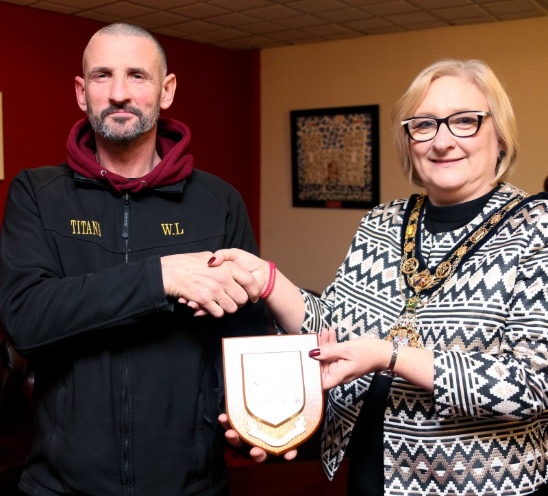 Head Coach Willie Lowry receives a Coat of Arms from the Mayor of Causeway Coast and Glens Borough Council Councillor Brenda Chivers at a recent civic reception held in recognition of the achievements of Limavady Titans Kickboxing Club.
