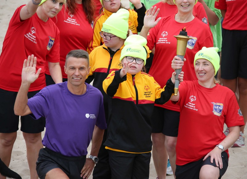 The Chief Executive of Causeway Coast and Glens Borough Council David Jackson pictured with Lucia, one of the Special Olympics athletes and members of the Law Enforcement Torch Run team during the Flame of Hope’s visit to Portrush