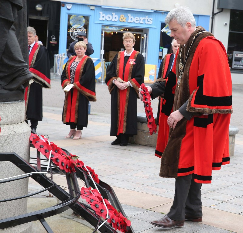 The Mayor of Causeway Coast and Glens Borough Council Councillor Richard Holmes prepares to lay a wreath at the War Memorial in Coleraine during the VJ Day service.