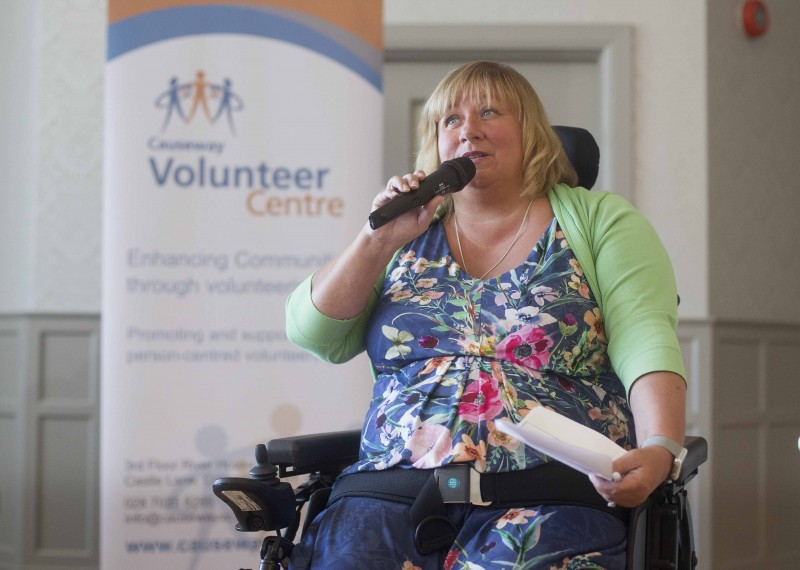Joann Dunseith speaks at the event about her experience as a volunteer.